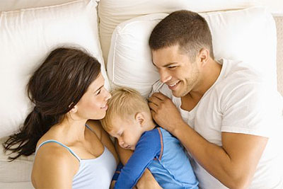 Happy Family In Bed